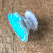 raccoon with dino phone holder