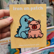 dino with capybara iron-on patch